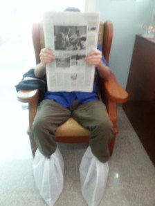BB waits in dentist office number 2. Shoes must come off, but instead they covered his. Fear of stinky feet?