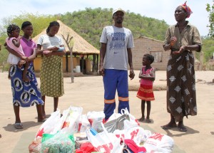 Village huts in background. Our food gifts, center.